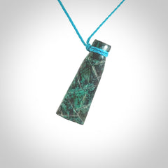 This is a hand carved drop pendant made from a gorgeous and striking piece of African Turquoise stone. For sale online from NZ Pacific. Delivered with adjustable blue cord.