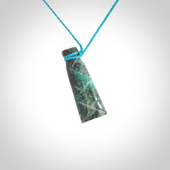 This is a hand carved drop pendant made from a gorgeous and striking piece of African Turquoise stone. For sale online from NZ Pacific. Delivered with adjustable blue cord.