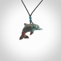 This is a hand carved dolphin pendant made from a gorgeous and striking piece of African Turquoise stone. This is a superbly carved and very unique dolphin necklace. For sale online from NZ Pacific. Delivered with adjustable cord.