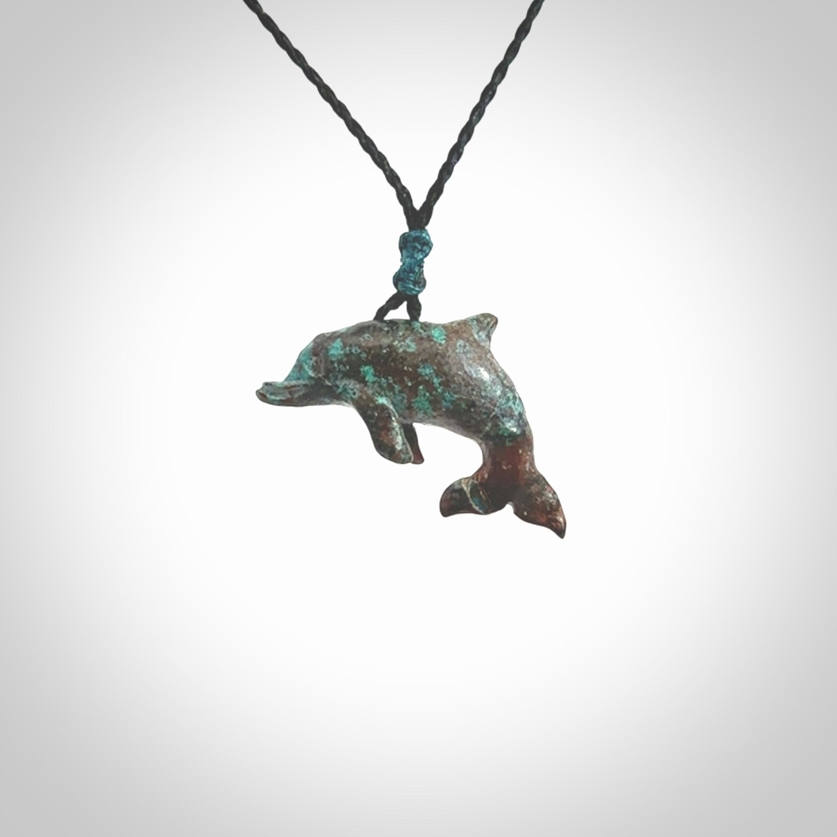 This is a hand carved dolphin pendant made from a gorgeous and striking piece of African Turquoise stone. This is a superbly carved and very unique dolphin necklace. For sale online from NZ Pacific. Delivered with adjustable cord.