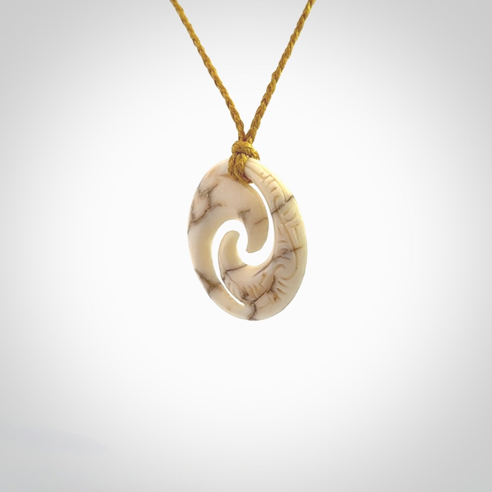 Carved koru pendant hand made in Woolly Mammoth tusk. These are a variety of colours from cream to dark brown.