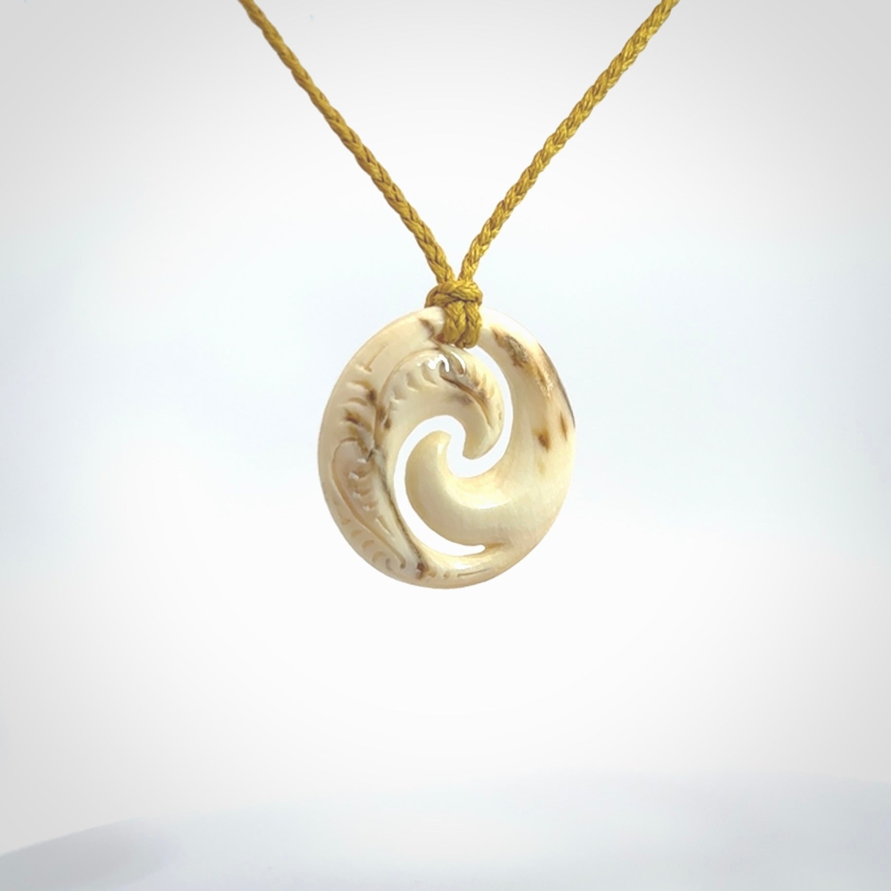 Carved koru pendant hand made in Woolly Mammoth tusk. These are a variety of colours from cream to dark brown.