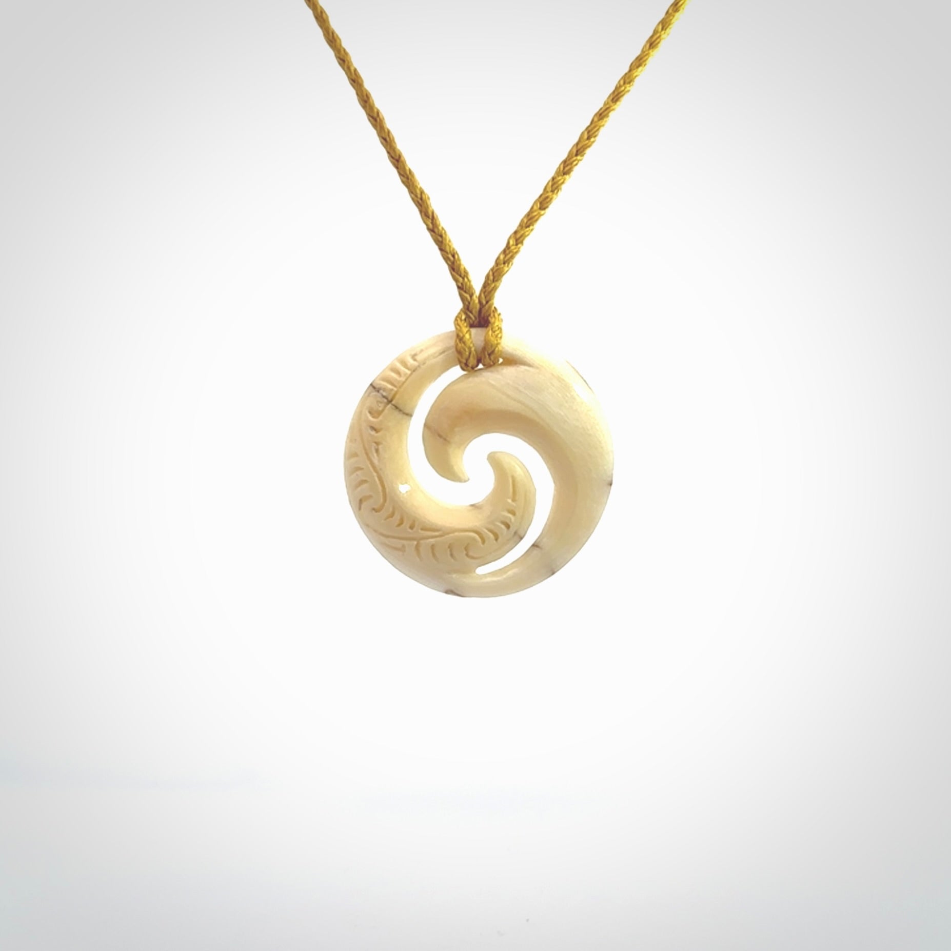 Carved koru pendant hand made in Woolly Mammoth tusk. These are a variety of colours from cream to dark brown.