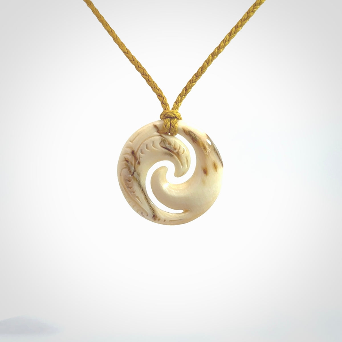 Carved koru pendant hand made in Woolly Mammoth tusk. These are a variety of colours from cream to dark brown.