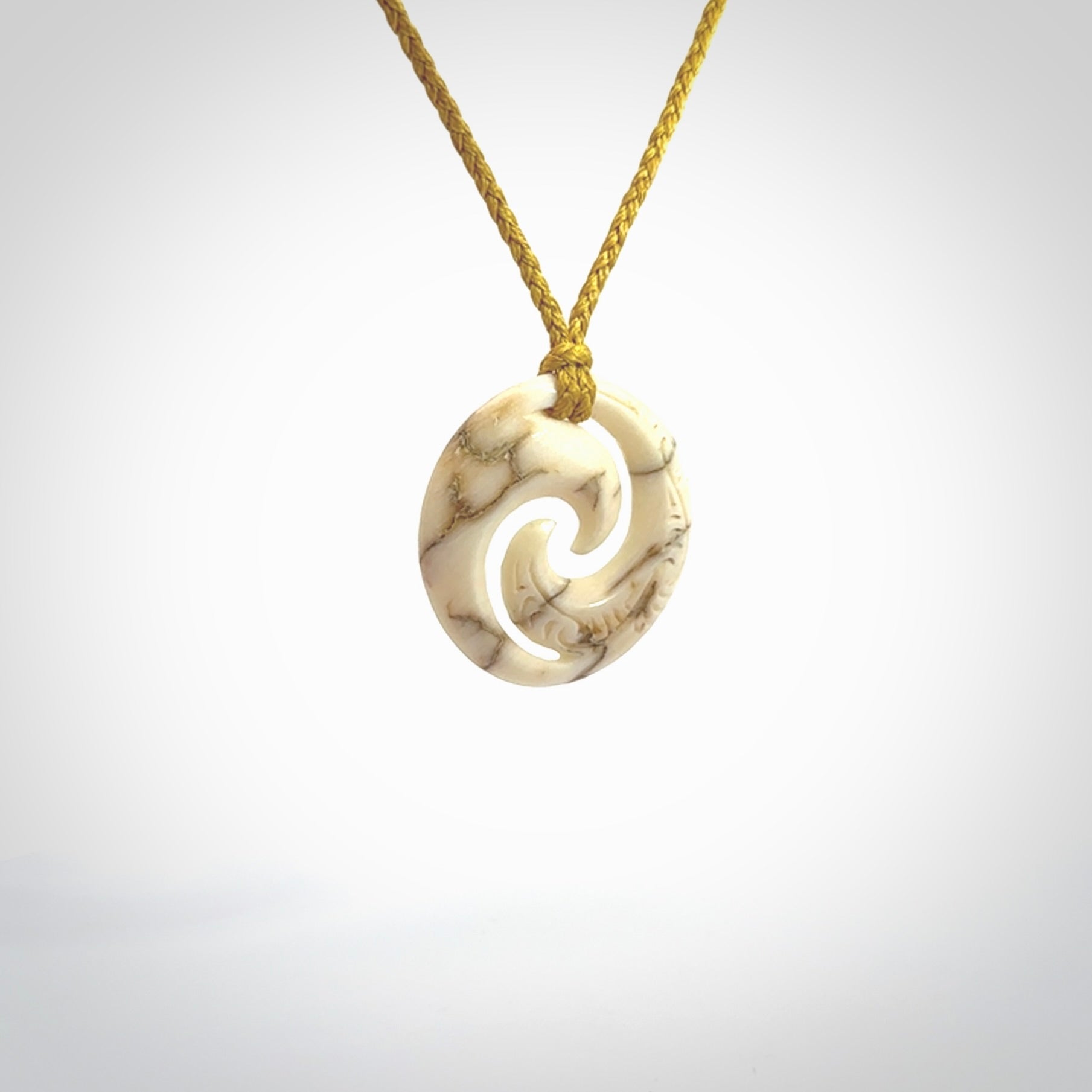 Carved koru pendant hand made in Woolly Mammoth tusk. These are a variety of colours from cream to dark brown.