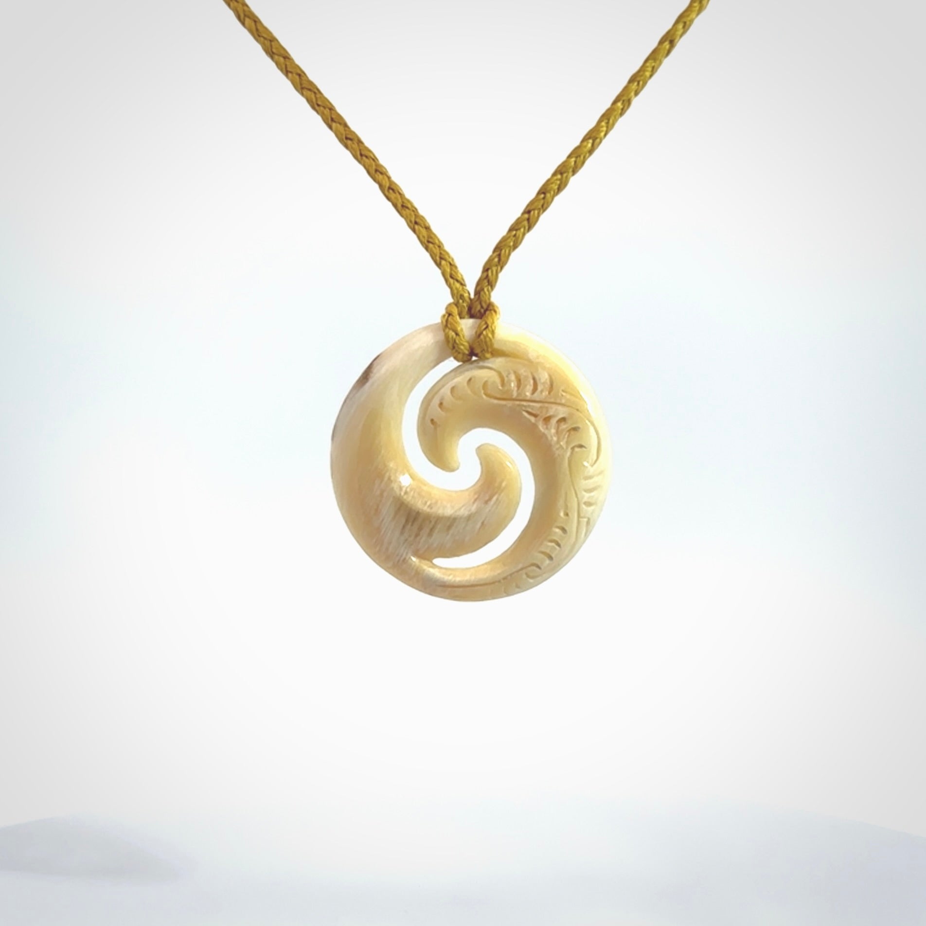 Carved koru pendant hand made in Woolly Mammoth tusk. These are a variety of colours from cream to dark brown.