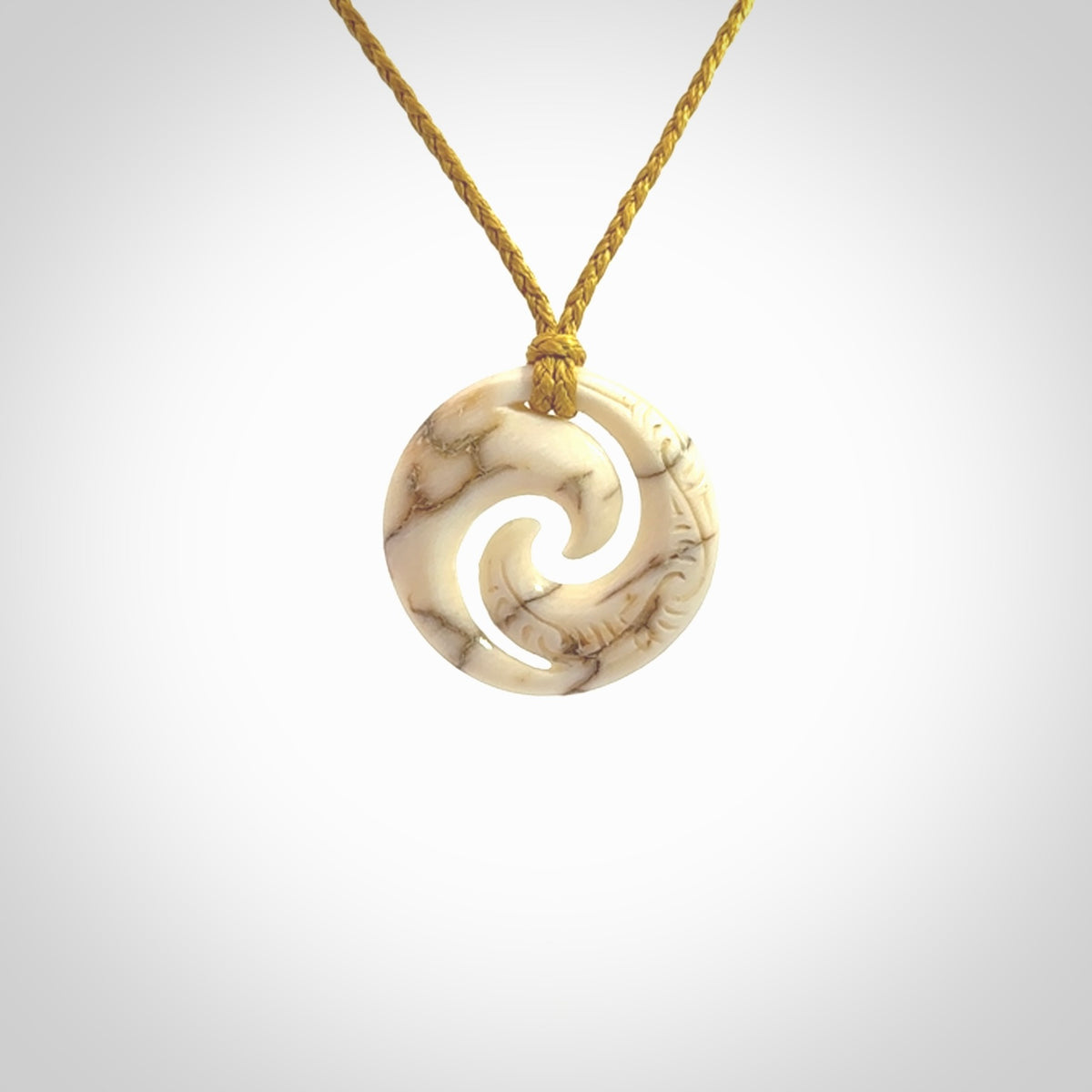 Carved koru pendant hand made in Woolly Mammoth tusk. These are a variety of colours from cream to dark brown.