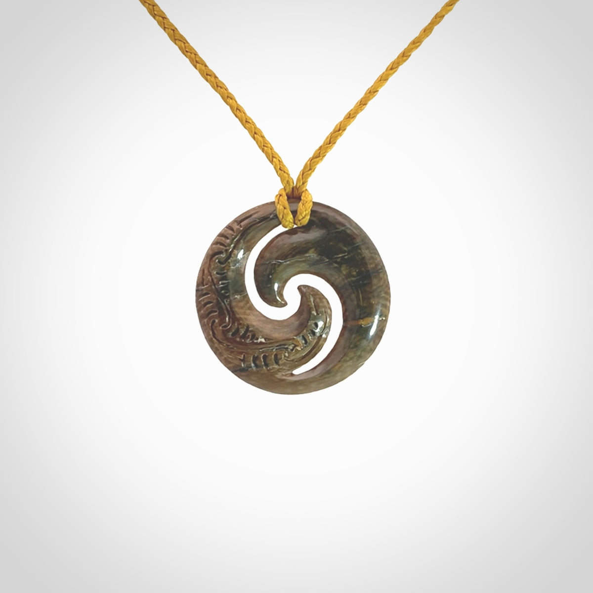 Carved koru pendant hand made in Woolly Mammoth tusk. These are a variety of colours from cream to dark brown.