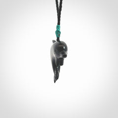 This is a hand carved dolphin pendant made from a gorgeous and striking piece of black jade stone. This is a superbly carved and very unique dolphin necklace. For sale online from NZ Pacific. Delivered with adjustable cord.