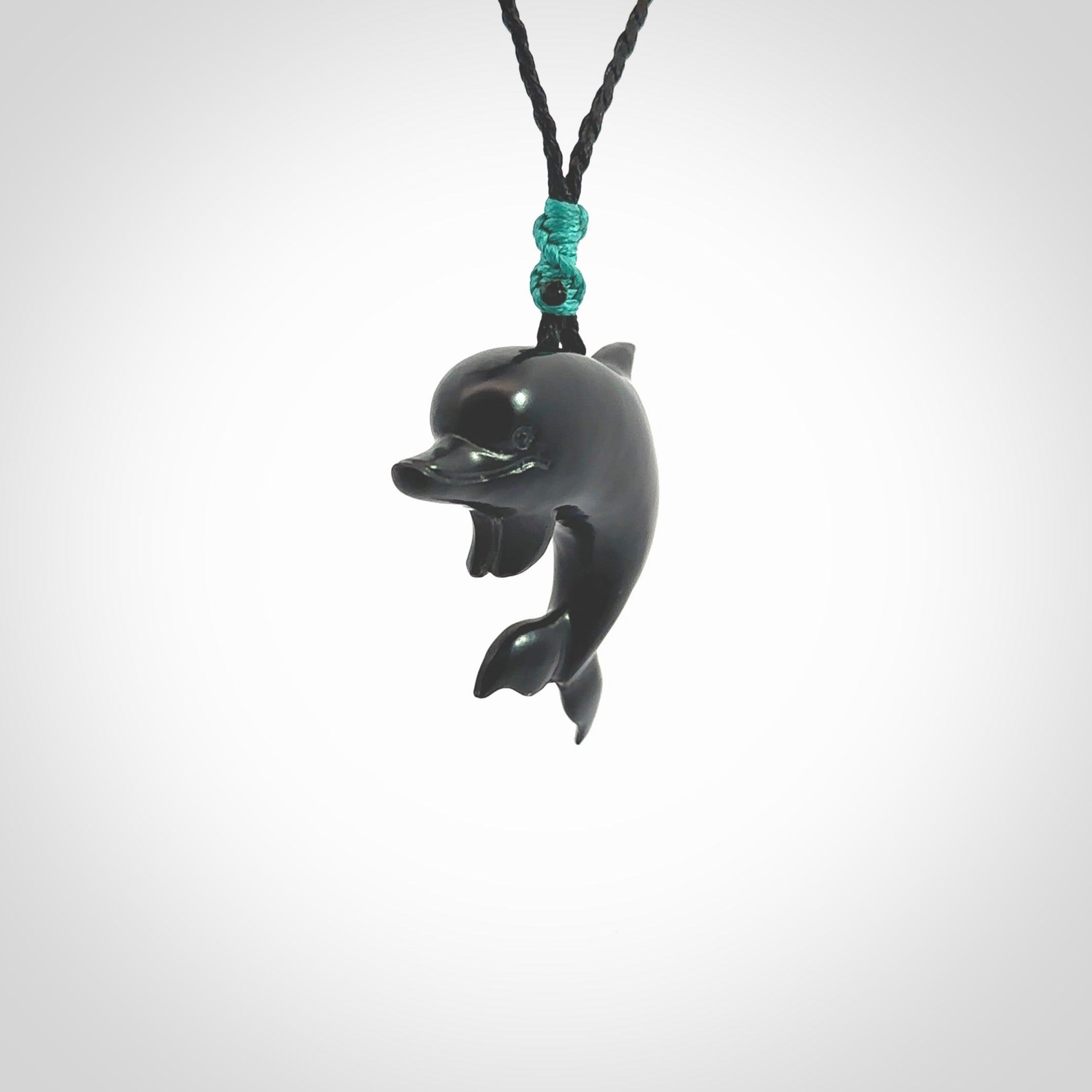 This is a hand carved dolphin pendant made from a gorgeous and striking piece of black jade stone. This is a superbly carved and very unique dolphin necklace. For sale online from NZ Pacific. Delivered with adjustable cord.