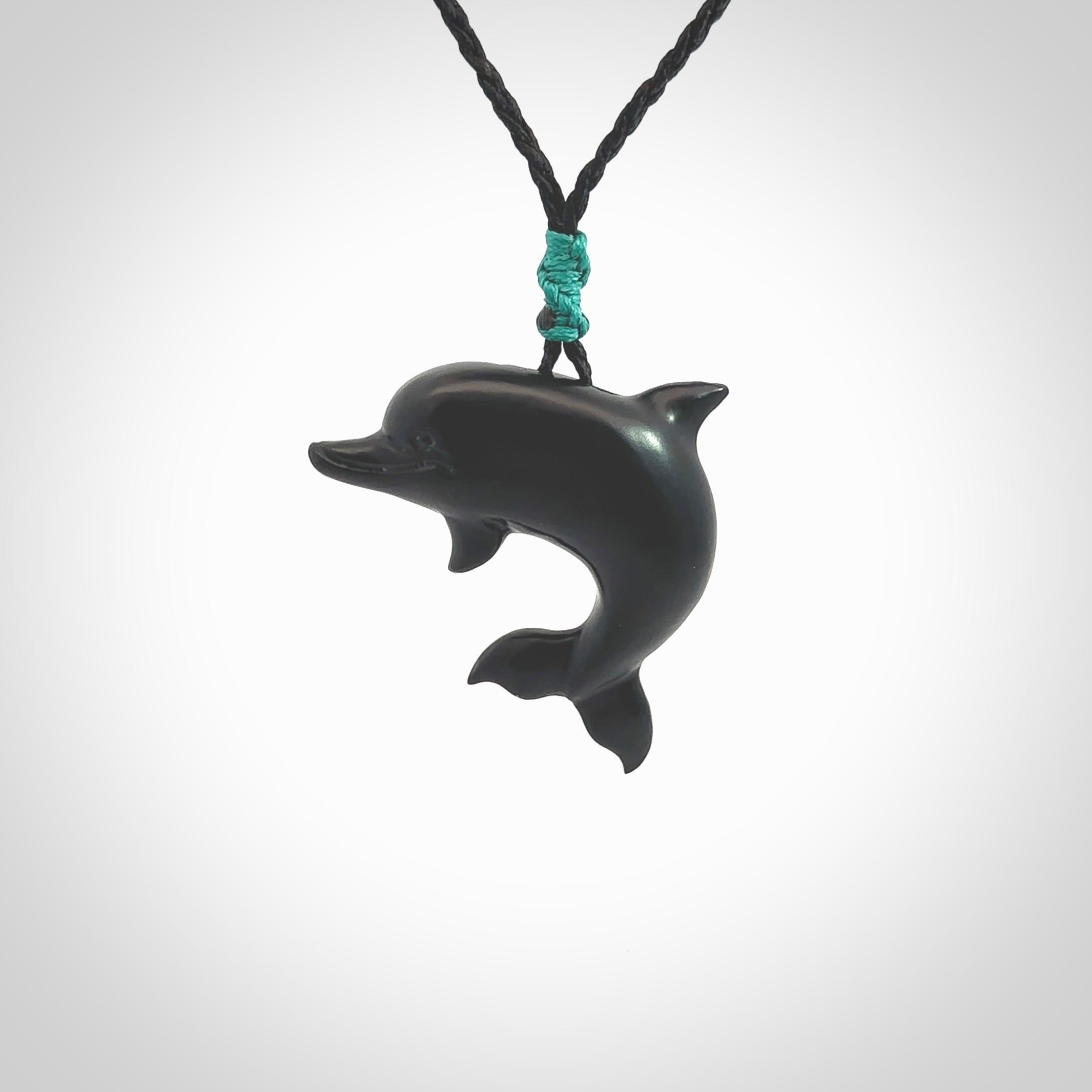 This is a hand carved dolphin pendant made from a gorgeous and striking piece of black jade stone. This is a superbly carved and very unique dolphin necklace. For sale online from NZ Pacific. Delivered with adjustable cord.