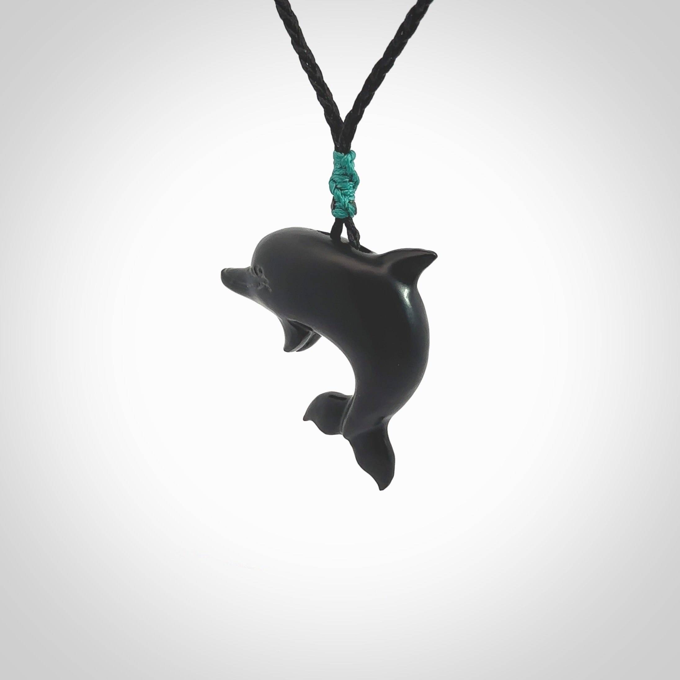 This is a hand carved dolphin pendant made from a gorgeous and striking piece of black jade stone. This is a superbly carved and very unique dolphin necklace. For sale online from NZ Pacific. Delivered with adjustable cord.