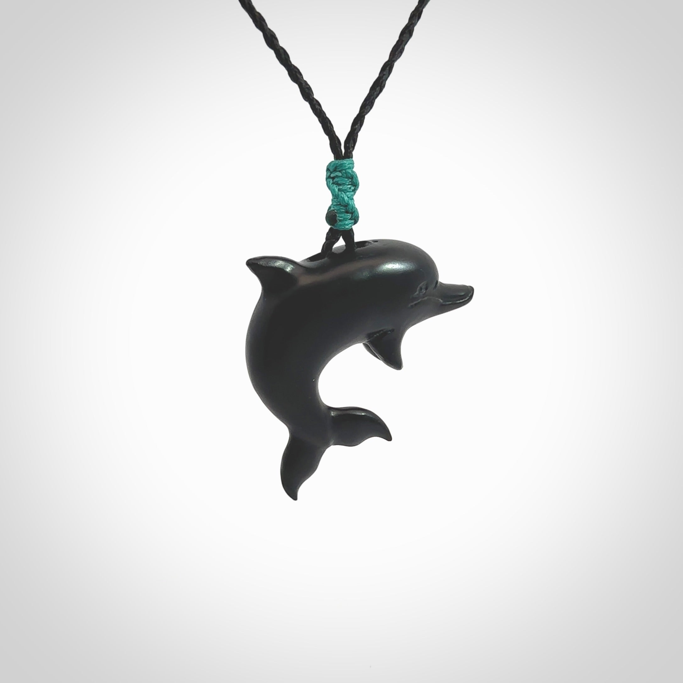 This is a hand carved dolphin pendant made from a gorgeous and striking piece of black jade stone. This is a superbly carved and very unique dolphin necklace. For sale online from NZ Pacific. Delivered with adjustable cord.