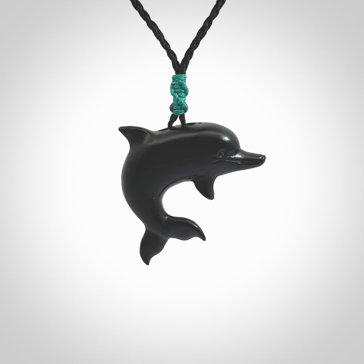 This is a hand carved dolphin pendant made from a gorgeous and striking piece of black jade stone. This is a superbly carved and very unique dolphin necklace. For sale online from NZ Pacific. Delivered with adjustable cord.