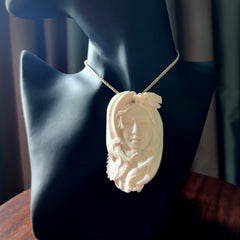 This is a hand carved bone woman with dragon pendant. It is made from bone and has an adjustable oat coloured cord. This is a large sized necklace and is a very unique, one only, pendant that is a piece for art lovers. One only pendant.