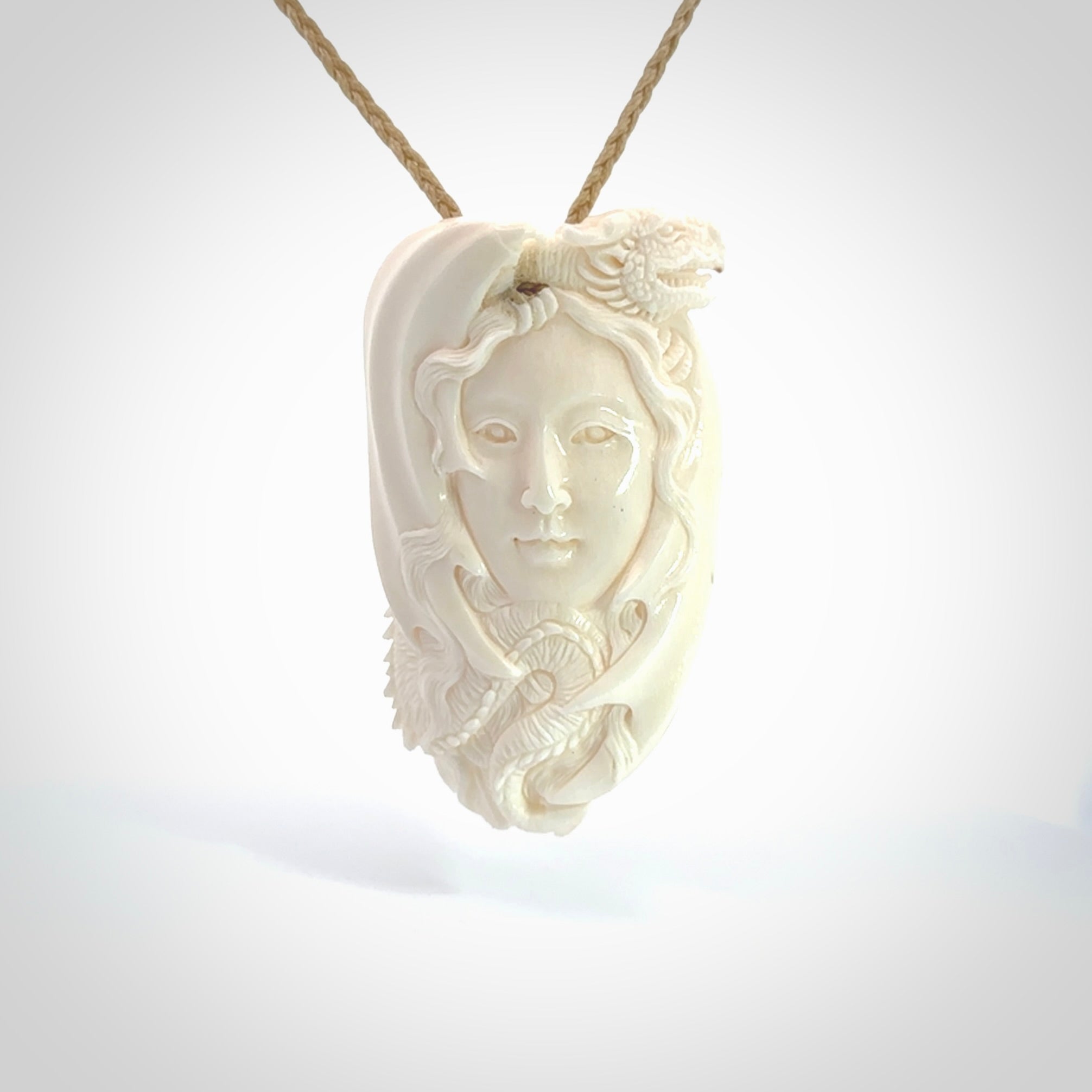 This is a hand carved bone woman with dragon pendant. It is made from bone and has an adjustable oat coloured cord. This is a large sized necklace and is a very unique, one only, pendant that is a piece for art lovers. One only pendant.