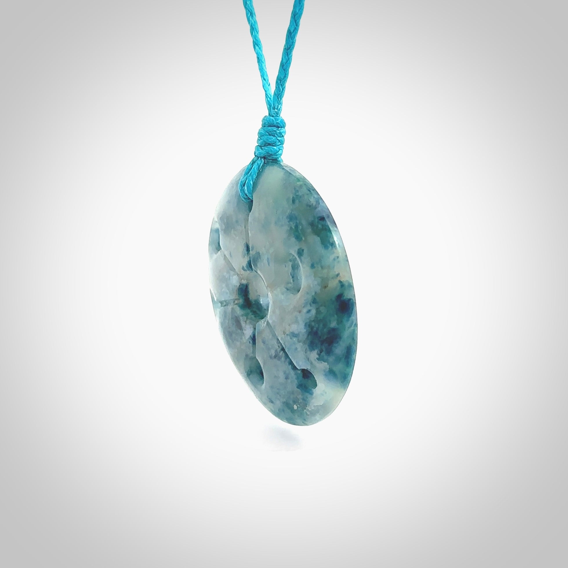 This is a handcrafted aotea stone contemporary disc pendant. This is a wonderful work of art hand made by Ana Krakosky. We ship this worldwide for free and are happy to answer any questions that you may have about these or other products on our website.