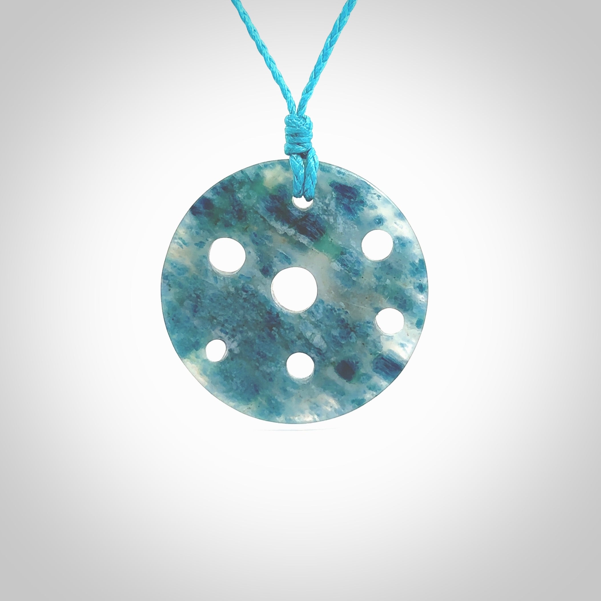 This is a handcrafted aotea stone contemporary disc pendant. This is a wonderful work of art hand made by Ana Krakosky. We ship this worldwide for free and are happy to answer any questions that you may have about these or other products on our website.