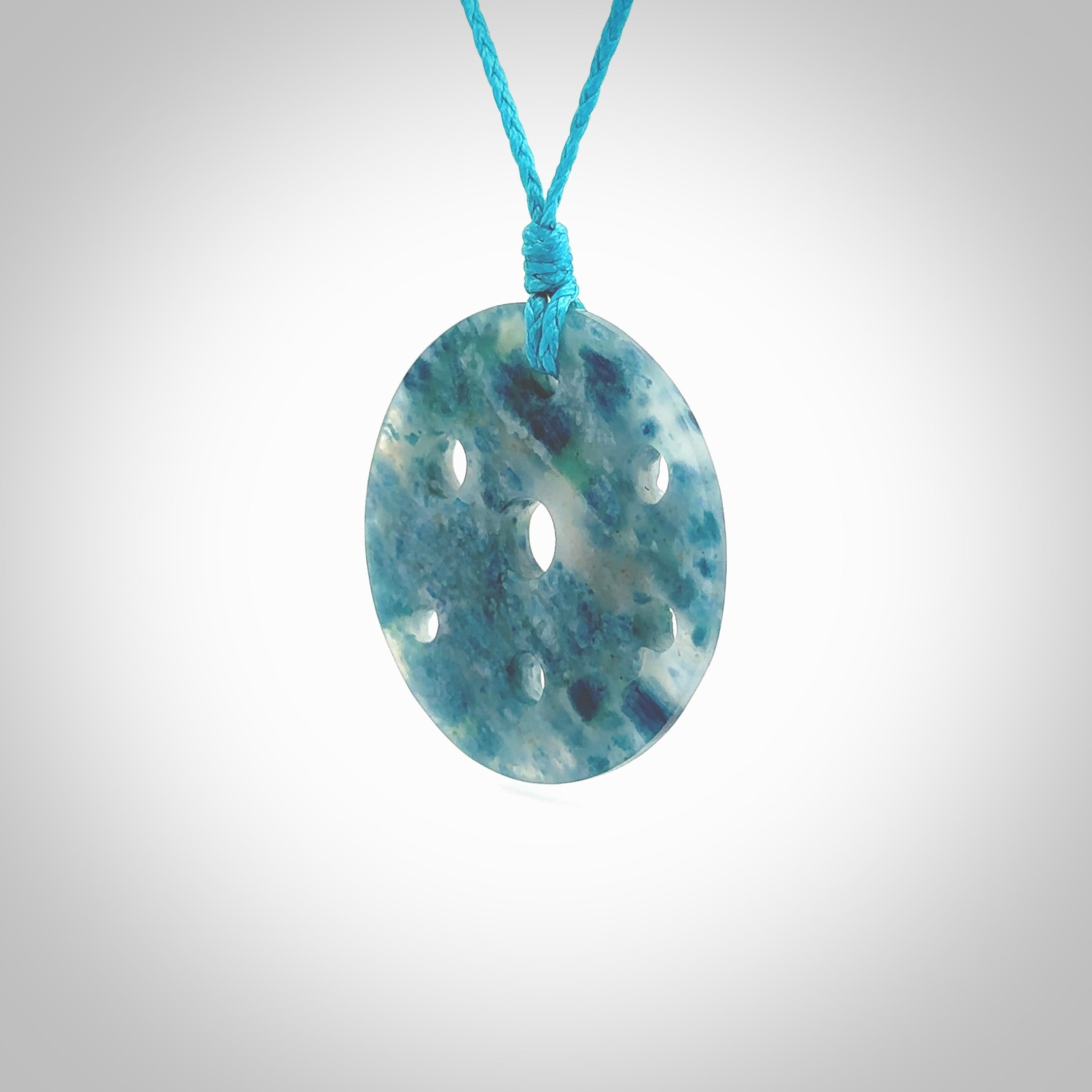 This is a handcrafted aotea stone contemporary disc pendant. This is a wonderful work of art hand made by Ana Krakosky. We ship this worldwide for free and are happy to answer any questions that you may have about these or other products on our website.