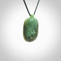 This picture shows a hand carved Jade face pendant. It is a varied green colour which is quite beautiful. Although a medium piece, it is a wonderful, delicate piece of jewellery. The cord is hand plaited and adjustable so that you can position the pendant where it suits you best. Delivery is free worldwide.