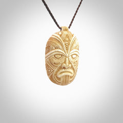 This picture shows a hand carved face pendant. It is carved from bone and although a medium piece, it is a wonderful, delicate piece of jewellery. The cord is hand plaited and adjustable so that you can position the pendant where it suits you best. Delivery is free worldwide.