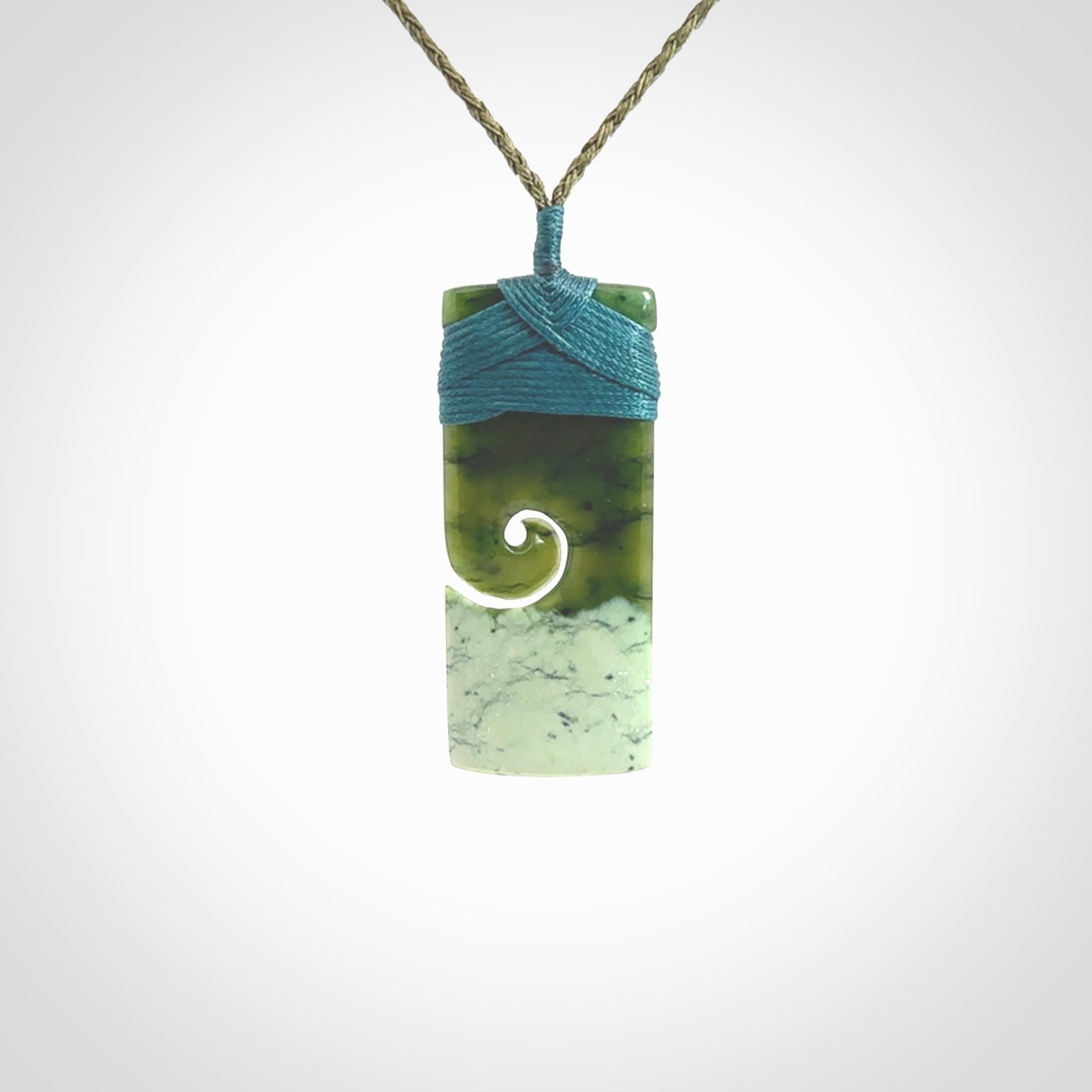 New Zealand jade toki koru pendant. Hand carved in New Zealand. Hand made jewellery. Provided with an adjustable cord.