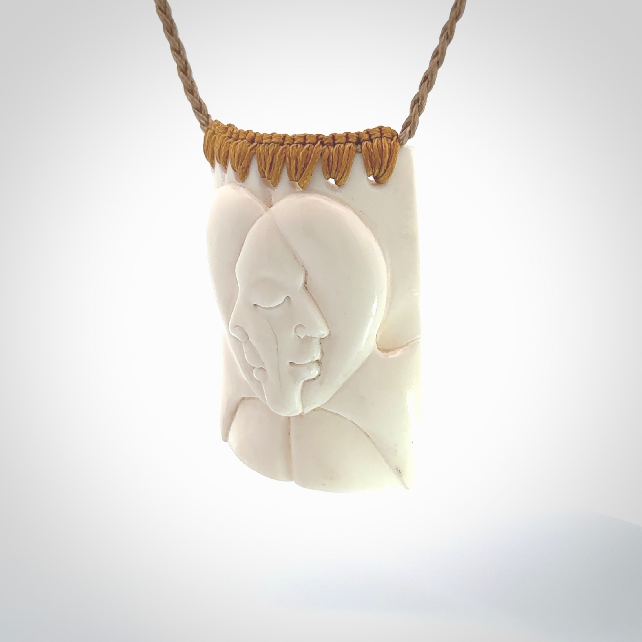 Hand carved large bone drop with double face carving. A stunning work of art. This pendant is hand carved in bone and provided with an adjustable cord. A one off work of art to wear by NZ Pacific.