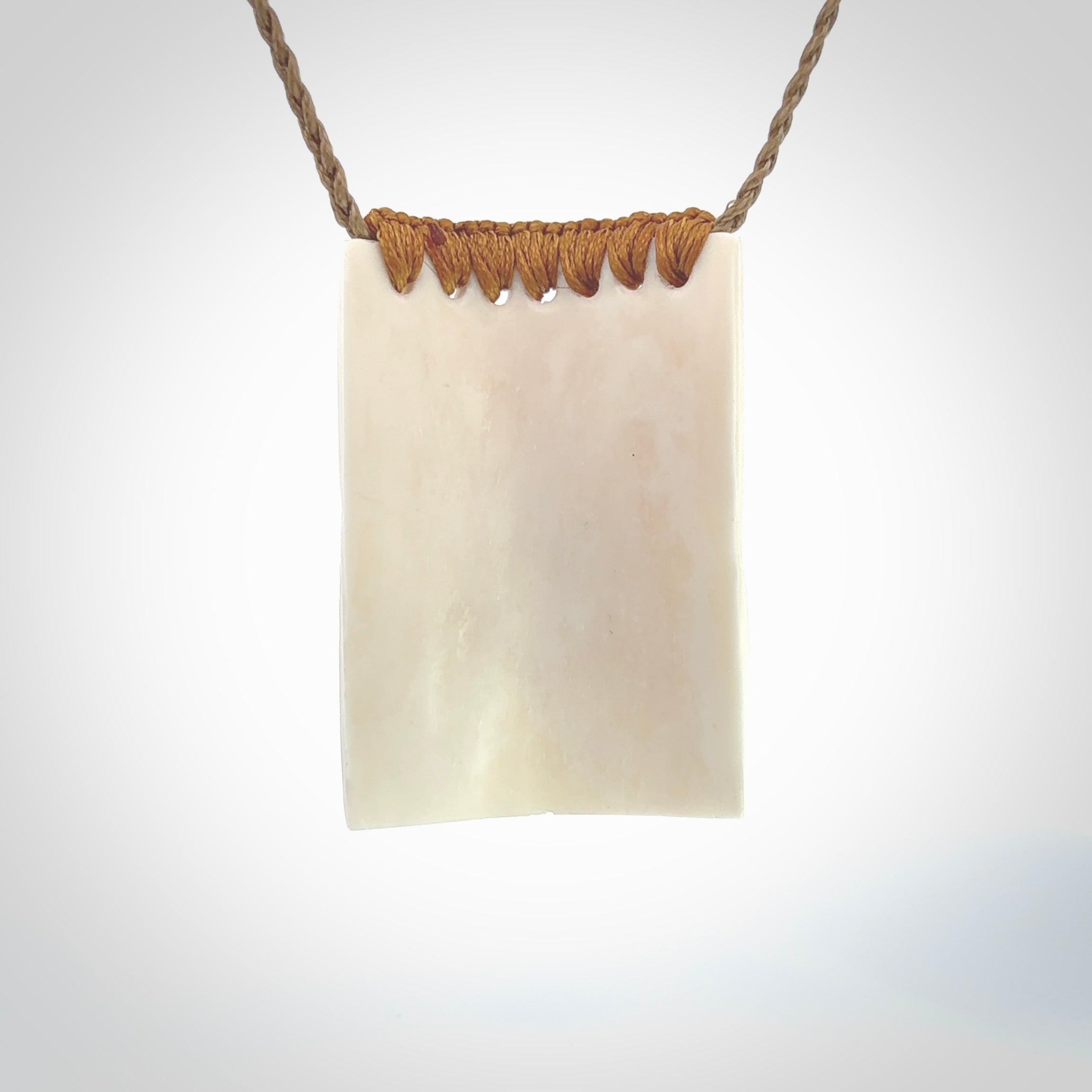 Hand carved large bone drop with double face carving. A stunning work of art. This pendant is hand carved in bone and provided with an adjustable cord. A one off work of art to wear by NZ Pacific.