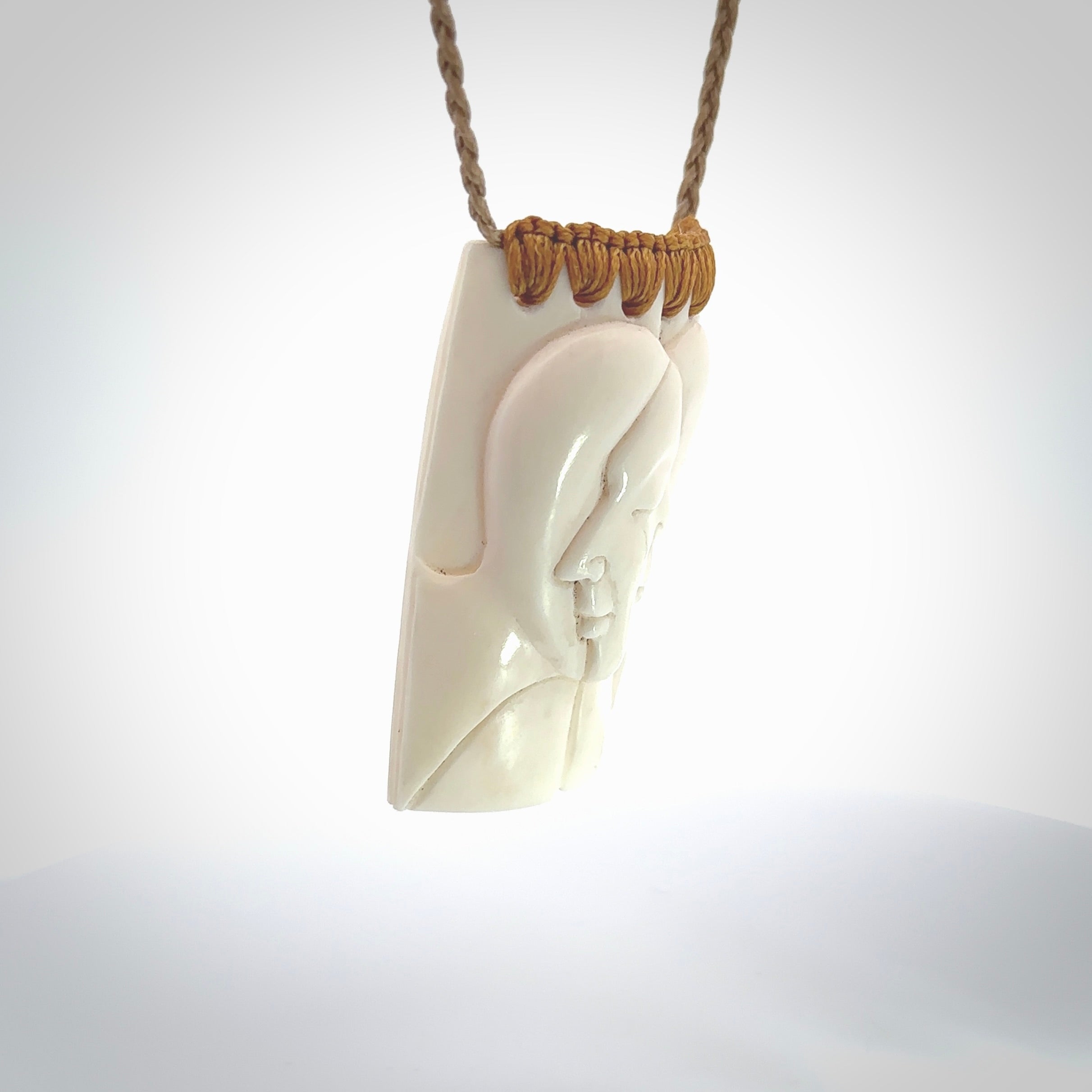 Hand carved large bone drop with double face carving. A stunning work of art. This pendant is hand carved in bone and provided with an adjustable cord. A one off work of art to wear by NZ Pacific.