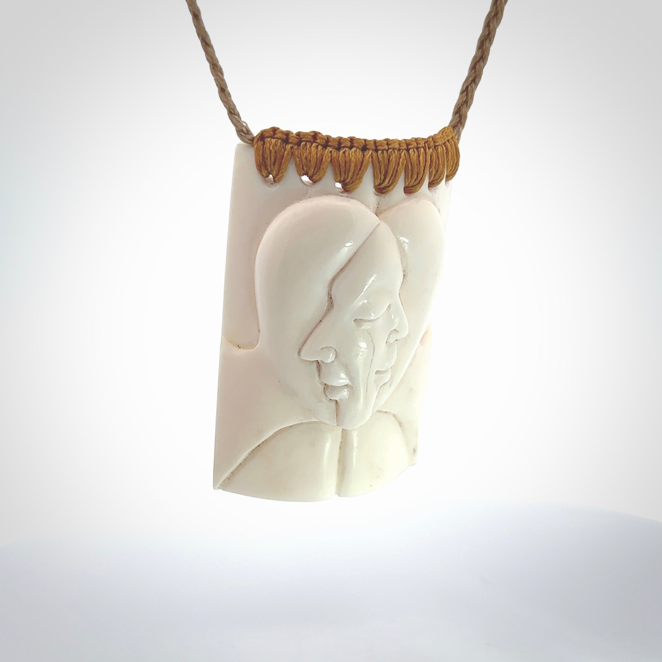 Hand carved large bone drop with double face carving. A stunning work of art. This pendant is hand carved in bone and provided with an adjustable cord. A one off work of art to wear by NZ Pacific.