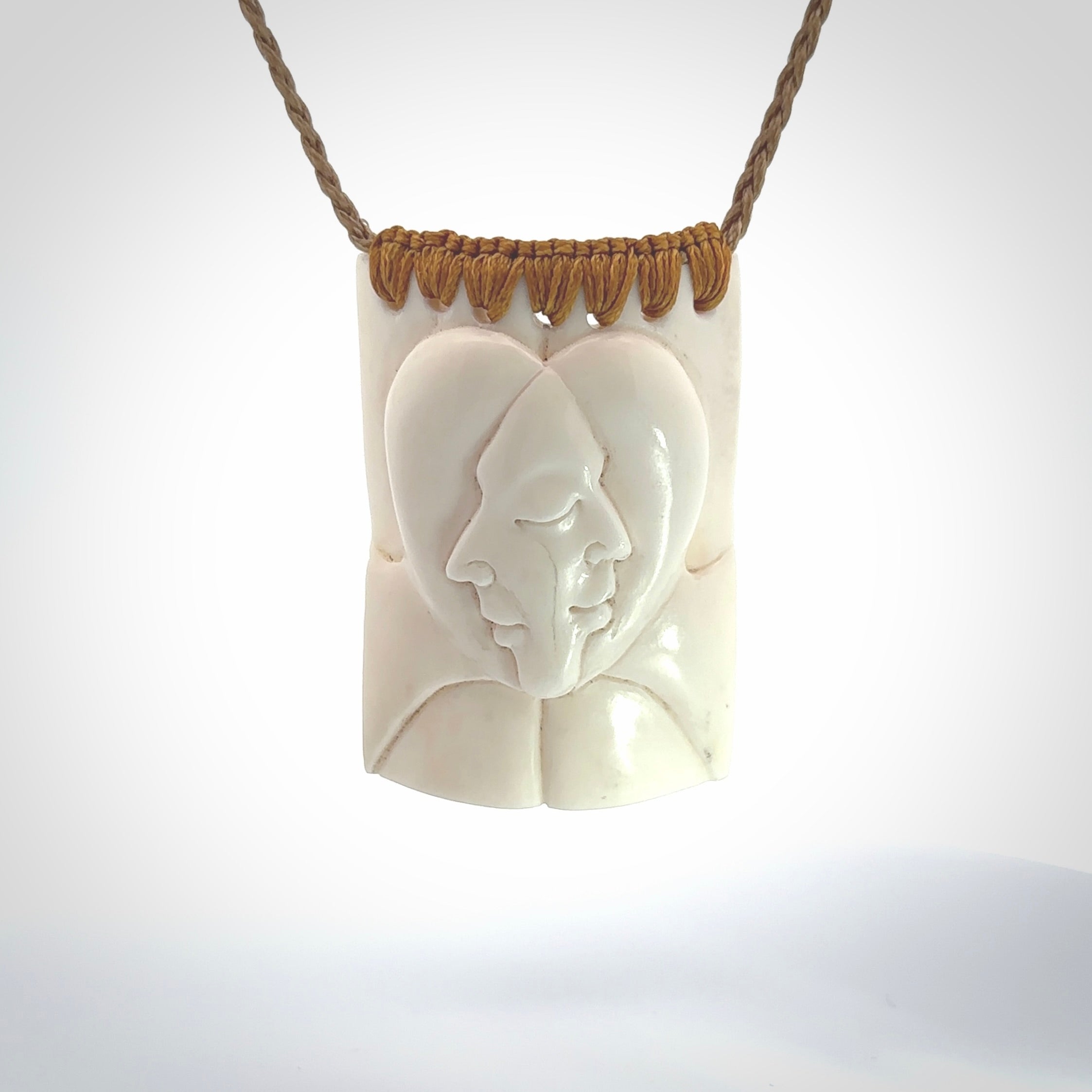 Hand carved large bone drop with double face carving. A stunning work of art. This pendant is hand carved in bone and provided with an adjustable cord. A one off work of art to wear by NZ Pacific.