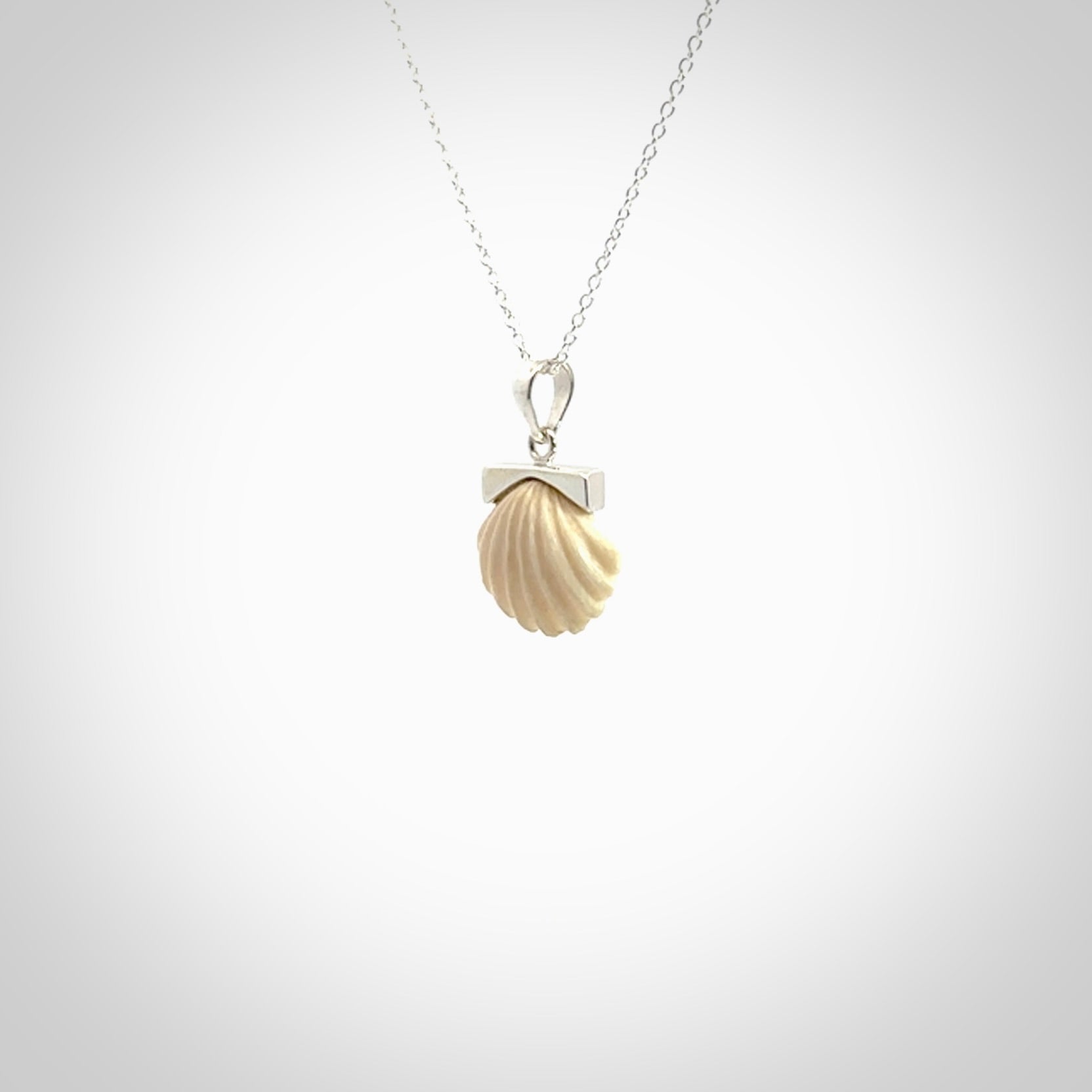 Hand made woolly mammoth tusk fanshell necklace with Sterling Silver. Mammoth tusk fanshell pendant with Sterling silver surround and chain. Made by NZ Pacific and sale online only.