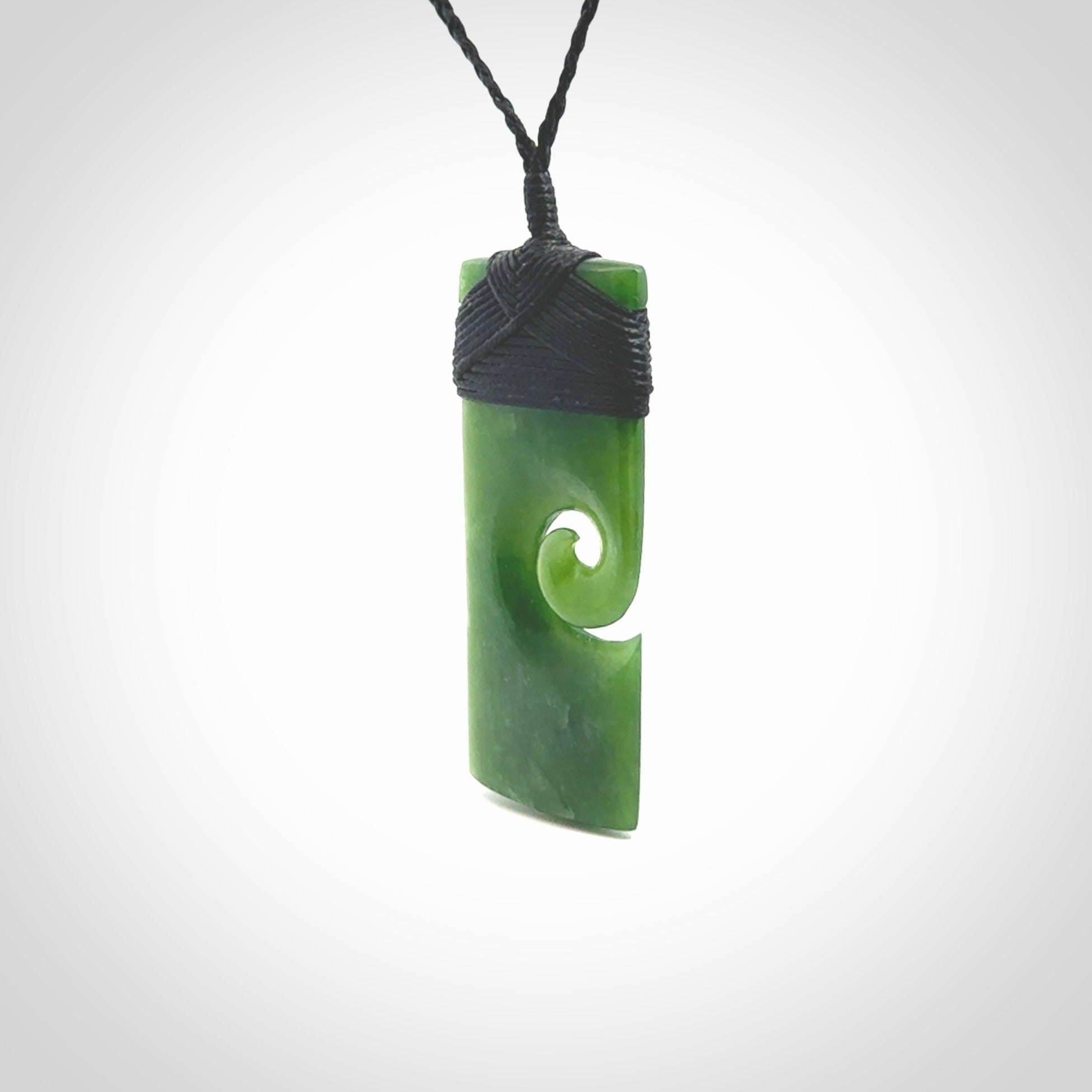 New Zealand jade toki koru pendant. Hand carved in New Zealand. Hand made jewellery. Provided with an adjustable cord.