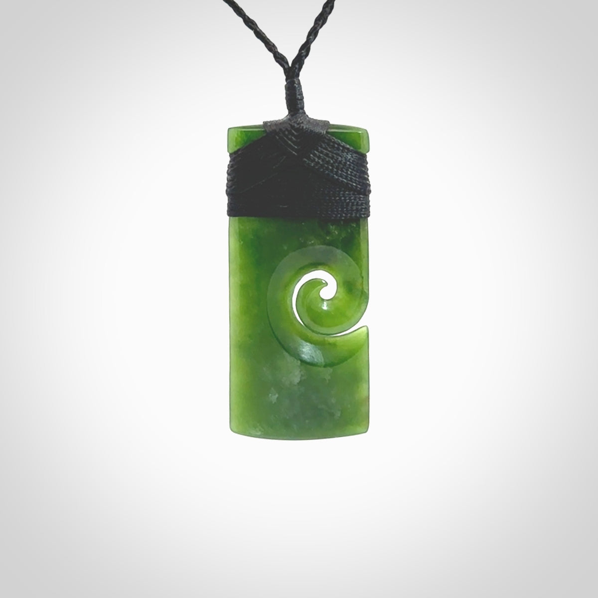 New Zealand jade toki koru pendant. Hand carved in New Zealand. Hand made jewellery. Provided with an adjustable cord.