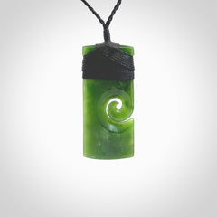 New Zealand jade toki koru pendant. Hand carved in New Zealand. Hand made jewellery. Provided with an adjustable cord.