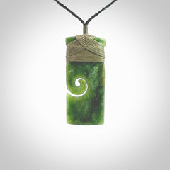 New Zealand jade toki koru pendant. Hand carved in New Zealand. Hand made jewellery. Provided with an adjustable cord.