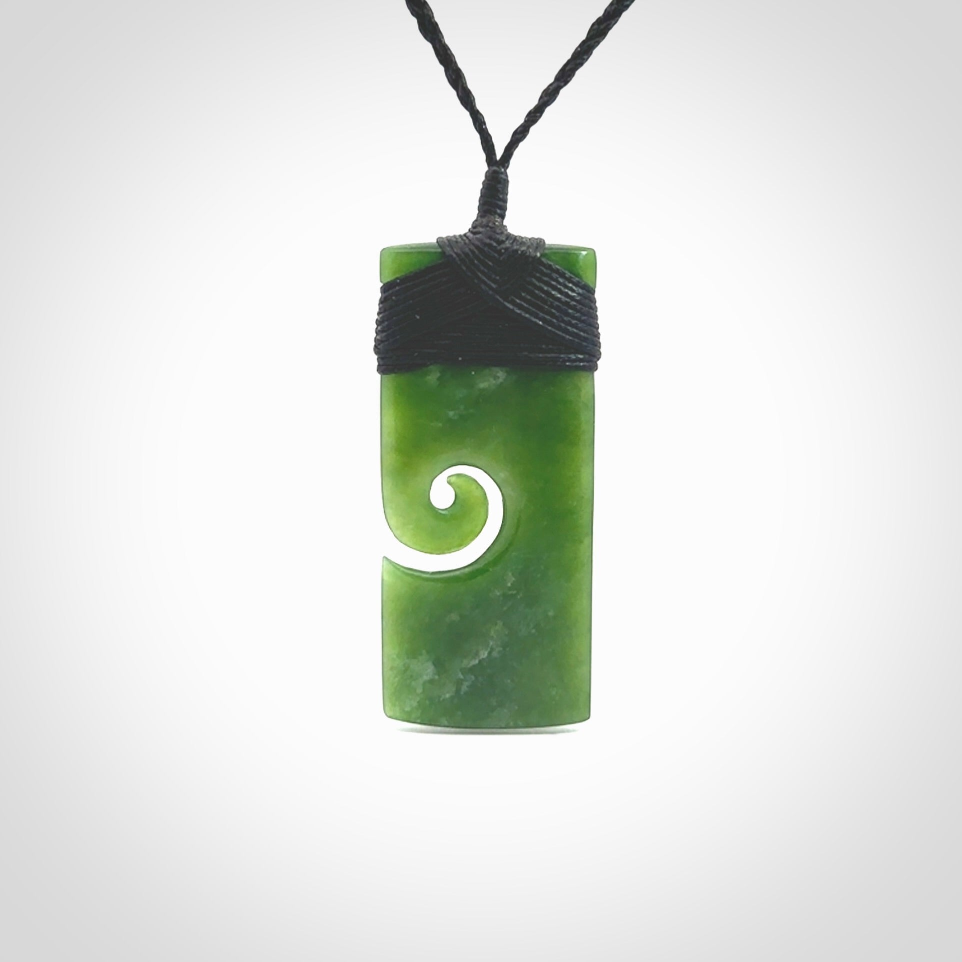 New Zealand jade toki koru pendant. Hand carved in New Zealand. Hand made jewellery. Provided with an adjustable cord.