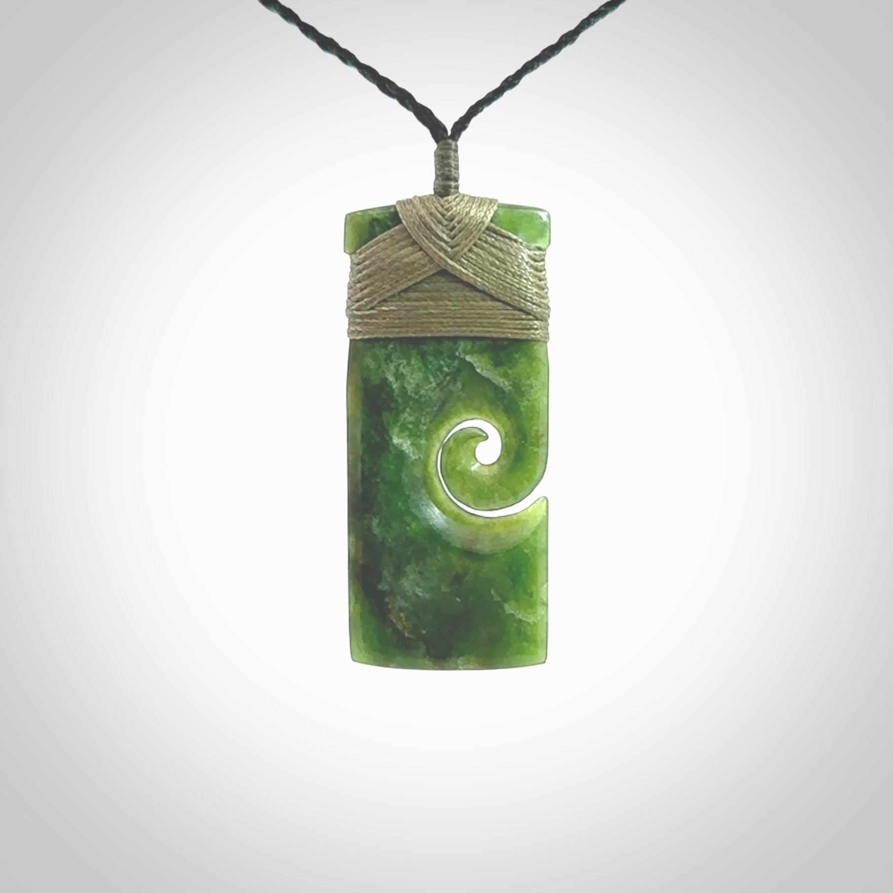 New Zealand jade toki koru pendant. Hand carved in New Zealand. Hand made jewellery. Provided with an adjustable cord.