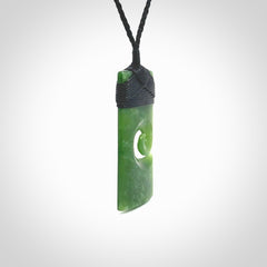 New Zealand jade toki koru pendant. Hand carved in New Zealand. Hand made jewellery. Provided with an adjustable cord.