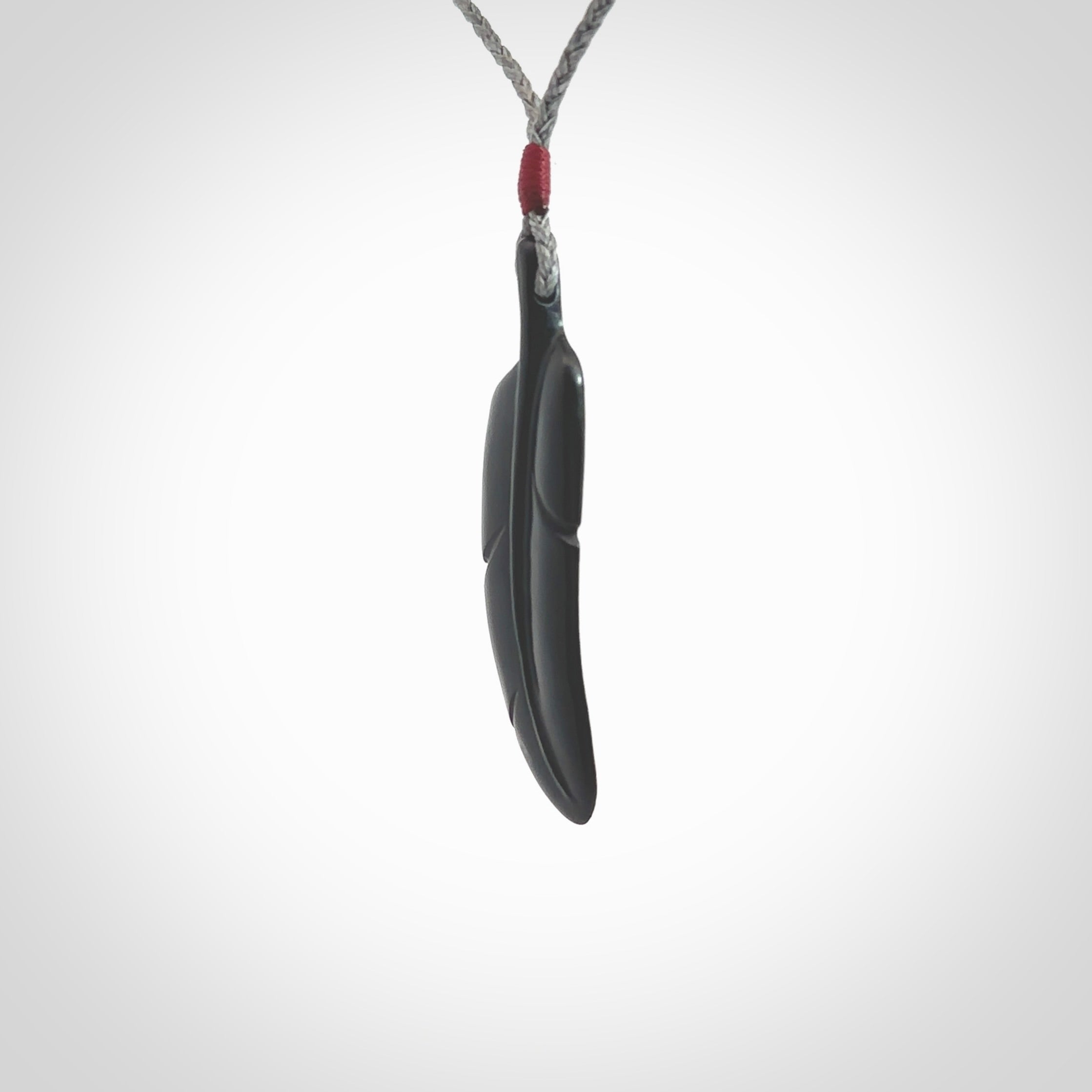 This is a hand carved feather pendant made from a gorgeous and striking piece of black jade stone. This is a superbly carved and very unique piece of contemporary jewellery. For sale online from NZ Pacific.