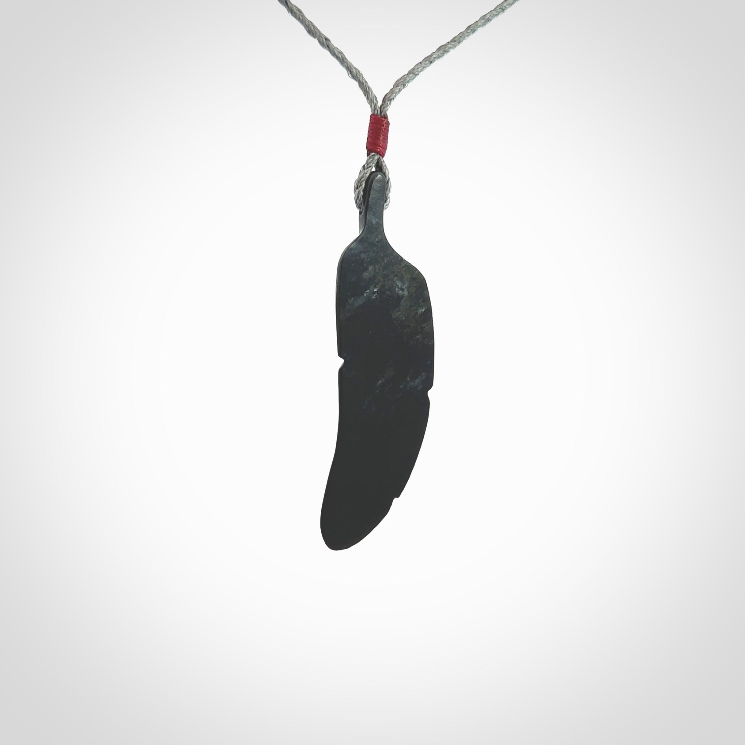 This is a hand carved feather pendant made from a gorgeous and striking piece of black jade stone. This is a superbly carved and very unique piece of contemporary jewellery. For sale online from NZ Pacific.