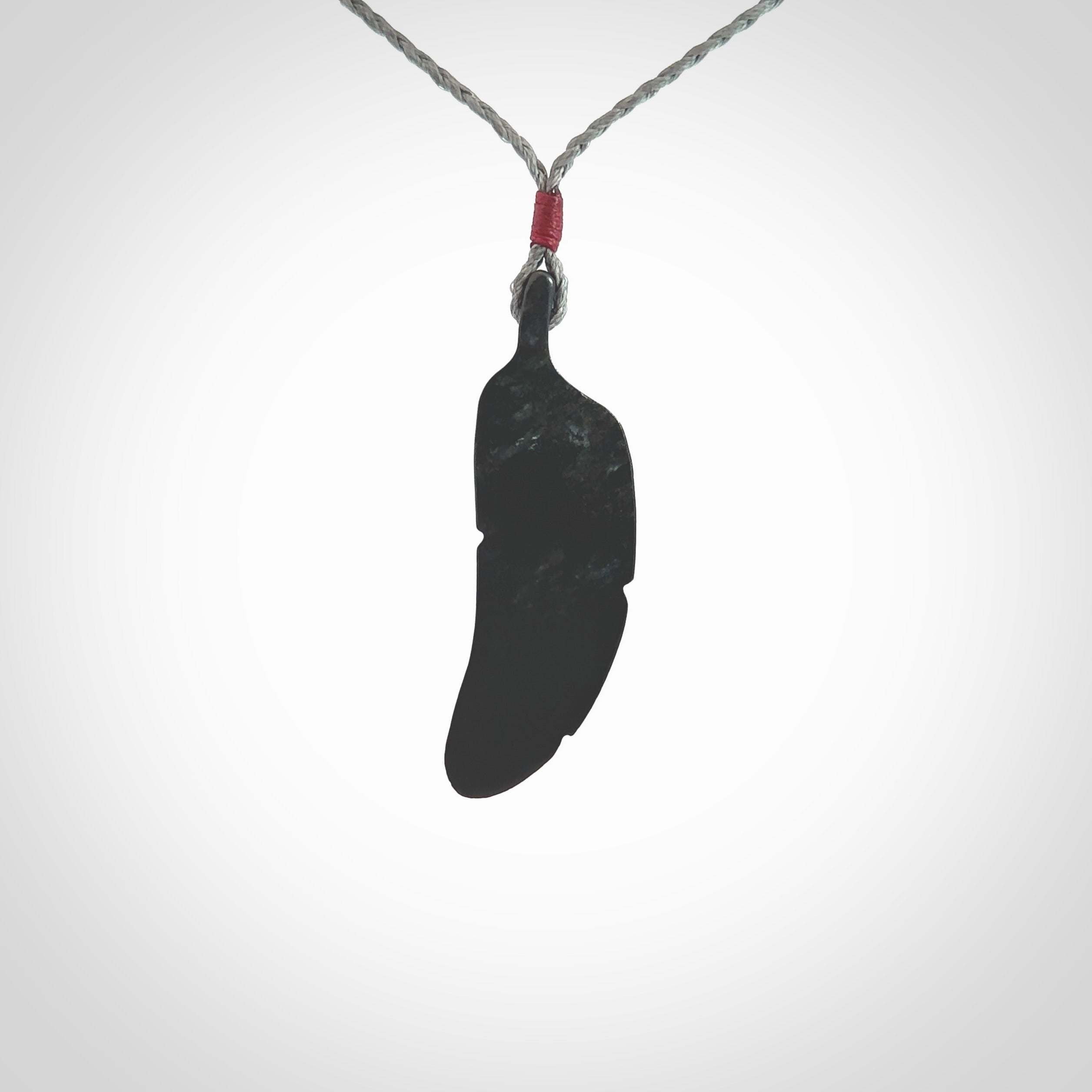 This is a hand carved feather pendant made from a gorgeous and striking piece of black jade stone. This is a superbly carved and very unique piece of contemporary jewellery. For sale online from NZ Pacific.