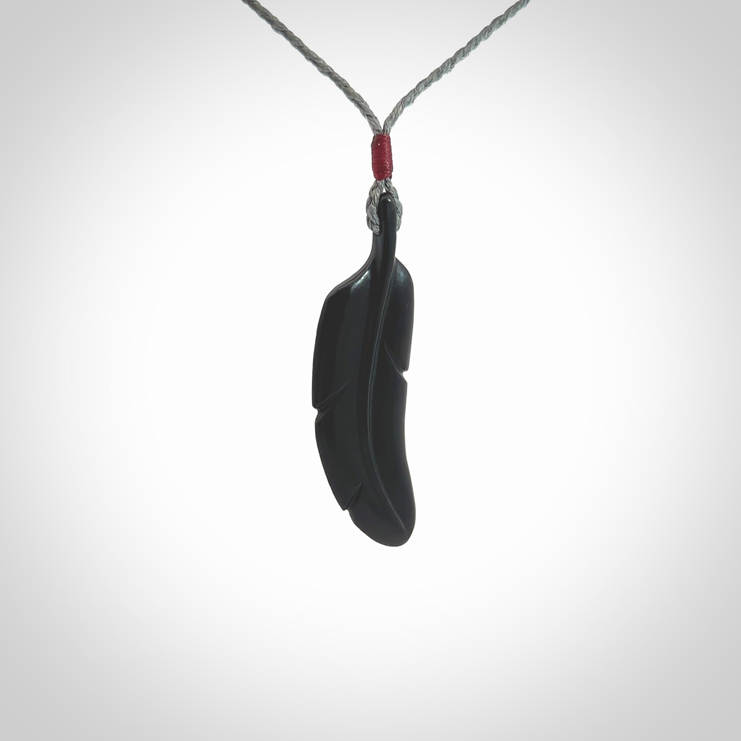 This is a hand carved feather pendant made from a gorgeous and striking piece of black jade stone. This is a superbly carved and very unique piece of contemporary jewellery. For sale online from NZ Pacific.