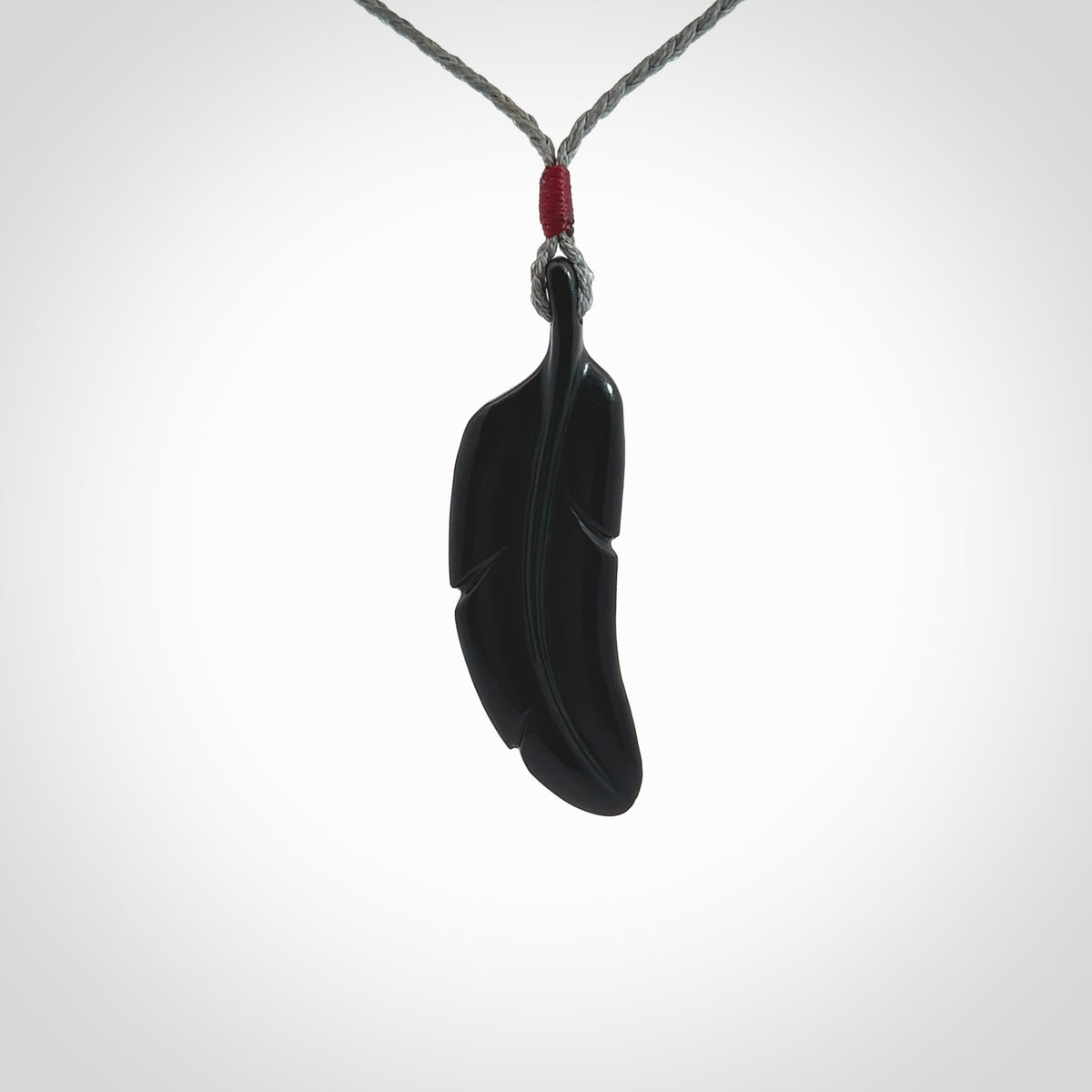 This is a hand carved feather pendant made from a gorgeous and striking piece of black jade stone. This is a superbly carved and very unique piece of contemporary jewellery. For sale online from NZ Pacific.