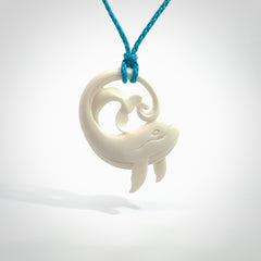 A hand carved bone whale pendant. This is a lovely piece carved to bring pleasure to the lucky wearer. It is a friendly pendant which we will ship to you free wherever you live. Carved by NZ Pacific and for sale online. Provided with an adjustable paradise blue cord.