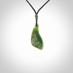 A lovely small sized New Zealand Marsden jade drop pendant. This piece is made from a deep green jade with orange specks and is a wonderful colour. Carved for NZ Pacific and delivered worldwide. Provided with an adjustable black cord.