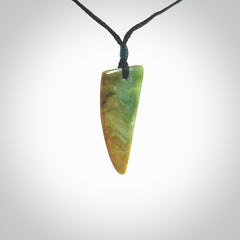 This photo shows a medium jade drop shaped pendant. It a a lovely varied green and orange New Zealand Marsden jade. The cord is black and is adjustable in length. One only medium, contemporary drop necklace from Jade.