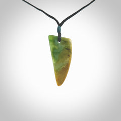 This photo shows a medium jade drop shaped pendant. It a a lovely varied green and orange New Zealand Marsden jade. The cord is black and is adjustable in length. One only medium, contemporary drop necklace from Jade.