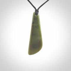 Hand carved small New Zealand Jade drop pendant. This pendant has been carved from New Zealand  jade by NZ Pacific. We sell this piece with an adjustable cord deliver to you with no extra cost for postage.