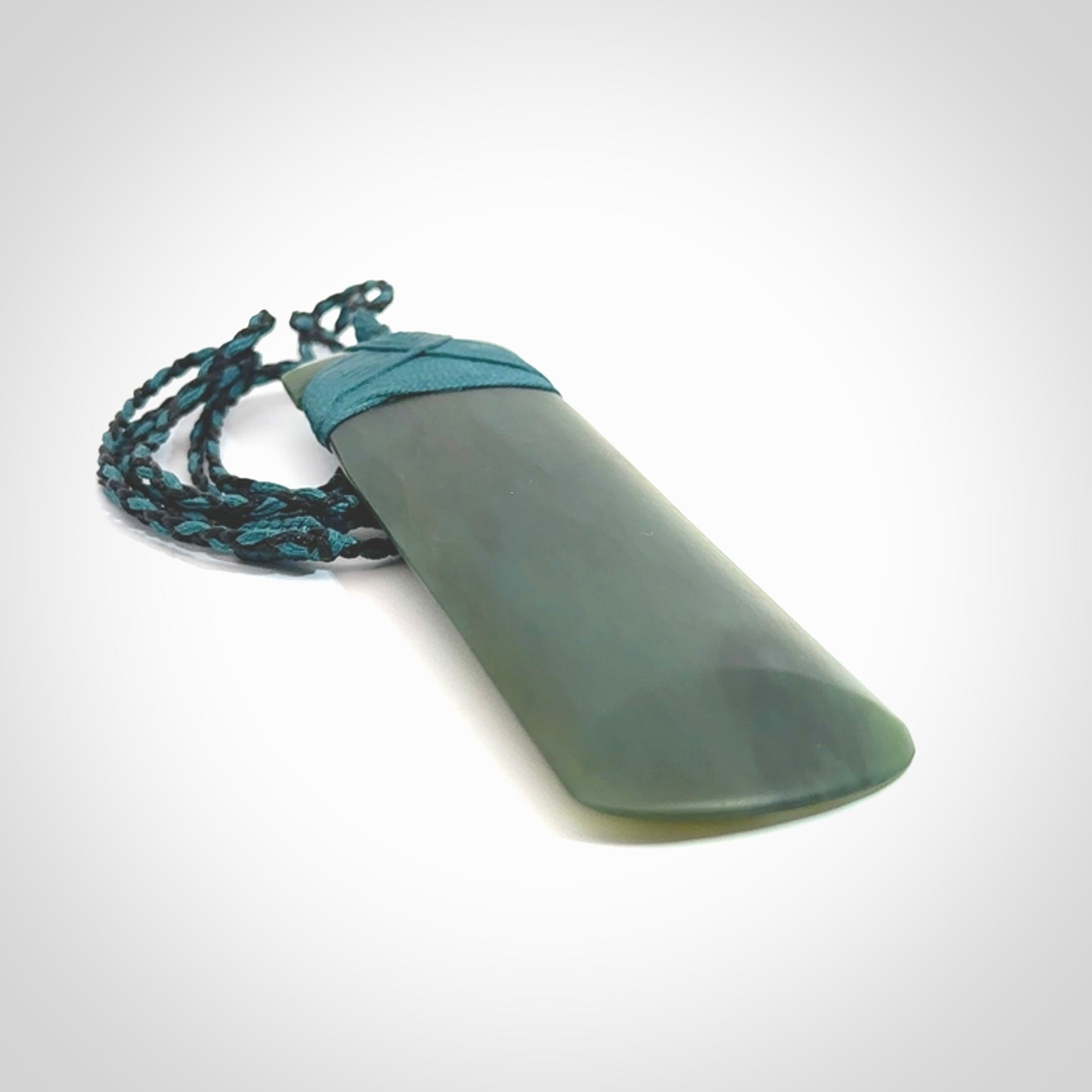 This is a lovely, one-off large, green toki pendant we've made from a gorgeous New Zealand jade. It is finished in a matte sheen and is bound with our plaited cord. These are wonderful pieces that are very attractive and will last a lifetime.